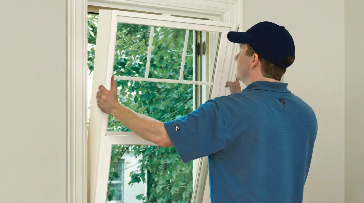Professional contractors performing a residential window insulation and replacement service in Rochester, NY